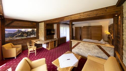 a hotel room with a king bed and a television at Steinbach-Hotel in Ruhpolding