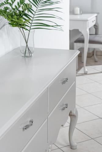 a white dresser with a plant in a vase on it at Dore Boutique Hotel in Agia Marina Nea Kydonias