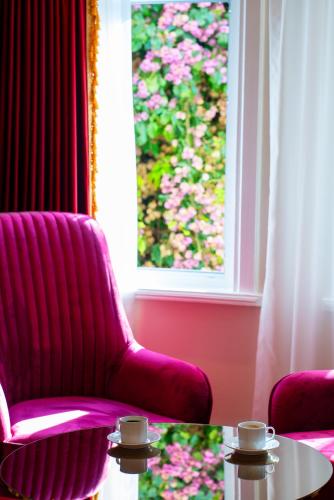 two chairs and a table in a room with a window at Ayasofya Hotel - Special Class in Istanbul