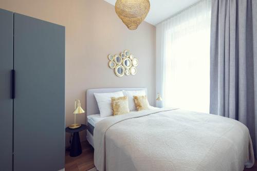 a bedroom with a white bed and a window at LeonArt Living 34 in Graz