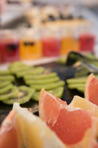 a close up of oranges and green fruit on a table at Dore Boutique Hotel in Agia Marina Nea Kydonias