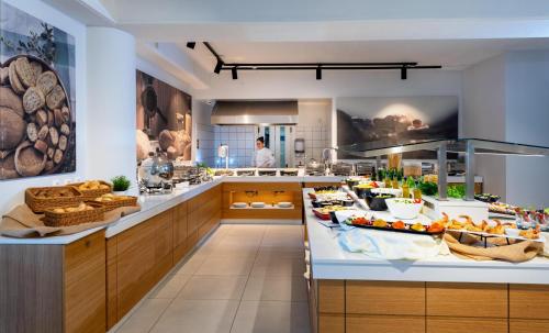 a kitchen with a buffet of food on a counter at Dore Boutique Hotel in Agia Marina Nea Kydonias