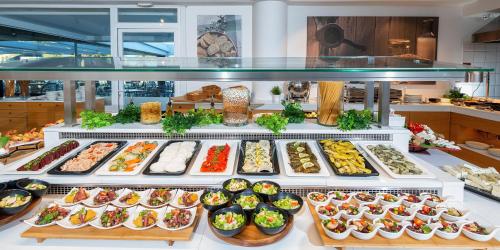 a display case with many different types of food at Dore Boutique Hotel in Agia Marina Nea Kydonias