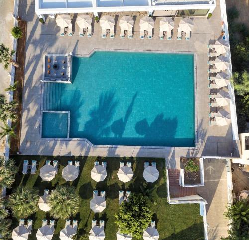 an overhead view of a swimming pool with chaise lounge chairs at Dore Boutique Hotel in Agia Marina Nea Kydonias