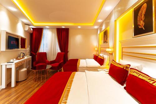 a hotel room with two beds and a desk at Ayasofya Hotel - Special Class in Istanbul