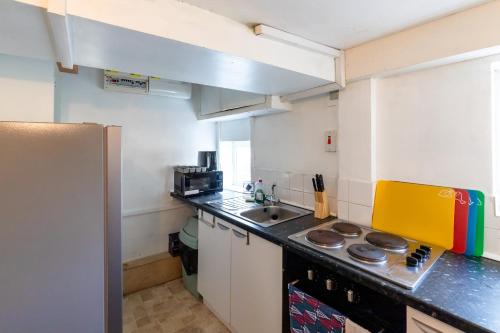 a small kitchen with a sink and a microwave at Glastonbury- Tor View- Studio in Glastonbury