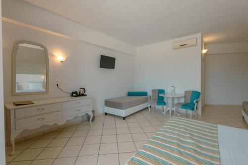 a bedroom with a bed and a mirror and a table at Dore Boutique Hotel in Agia Marina Nea Kydonias