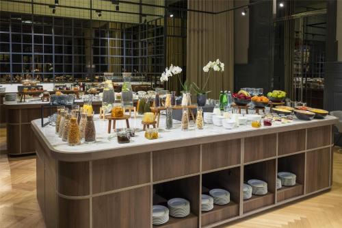 a buffet line with food on display in a building at NH Collection Prague Carlo IV in Prague