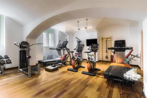 a gym with several treadmills and exercise bikes at NH Collection Prague Carlo IV in Prague