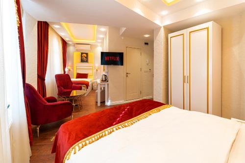 a hotel room with a bed and two chairs at Ayasofya Hotel - Special Class in Istanbul