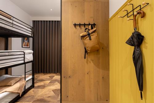 a bedroom with a yellow wall and a closet with an umbrella at Limerick City Hotel in Limerick