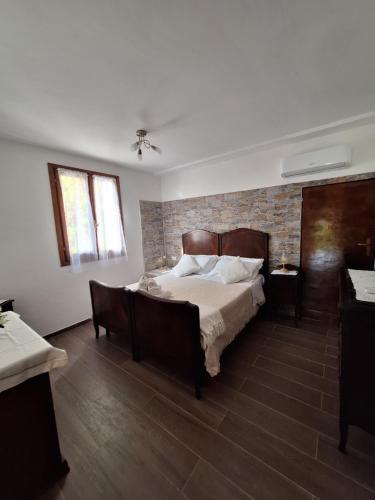 a bedroom with a bed and a brick wall at Terrace on the green in Monterosso al Mare