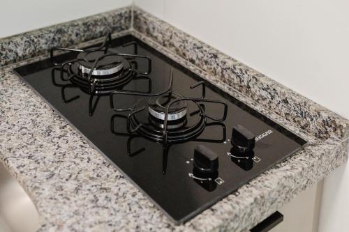 a stove top oven sitting on top of a counter at Allure Residence by Carpediem in Recife