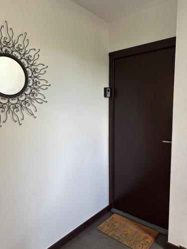 a black door with a mirror on a wall at Break Zen in Tulle