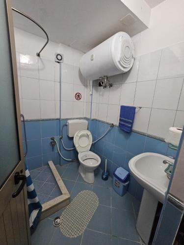 a small bathroom with a toilet and a sink at Traveler Hostel 2 in Shkodër