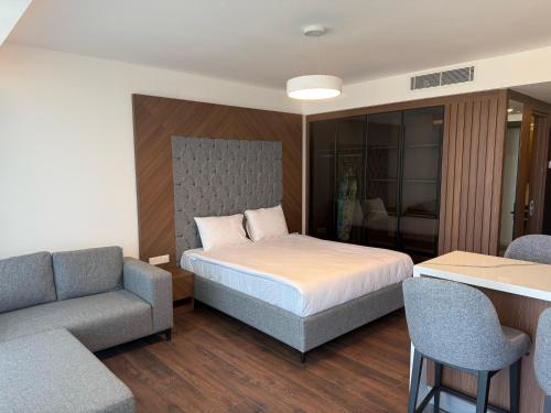 ein Hotelzimmer mit einem Bett und einer Couch in der Unterkunft Grand Sapphire Luxury Residence in Iskele