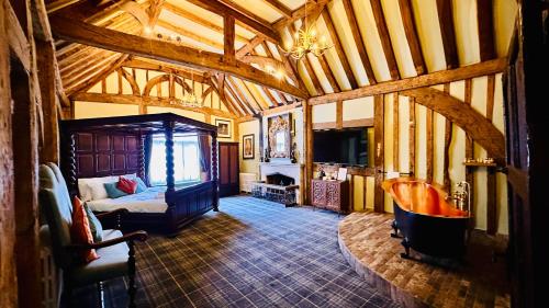 a room with a bed and a couch in a room at The Ostrich Inn Colnbrook London Heathrow in Slough
