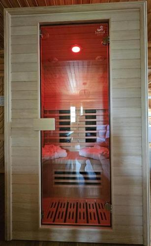 a glass door with a reflection of a room at Hôtel Résidence Le Pin Sylvestre Amnéville in Amnéville