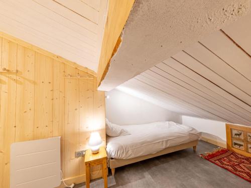 un lit dans une chambre avec un plafond en bois dans l'établissement Appartement duplex skis aux pieds, 3 pièces, 5 pers., wifi, balcon, et garage privé - FR-1-694-196, à Val dʼIsère