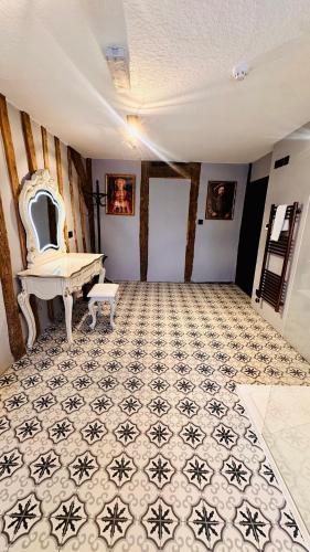 a room with a table and a bench on a tile floor at The Ostrich Inn Colnbrook London Heathrow in Slough