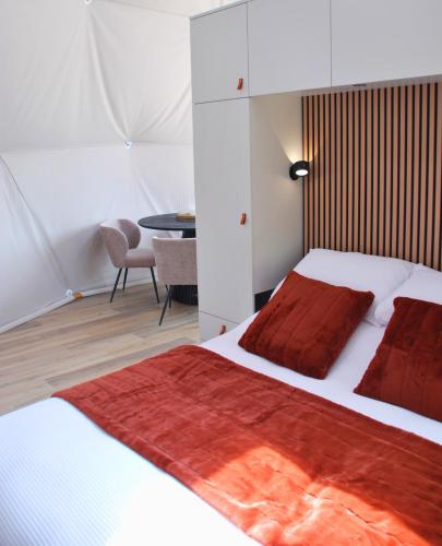 a bedroom with a bed and a table in a room at Kilima Retreats in West Quantoxhead
