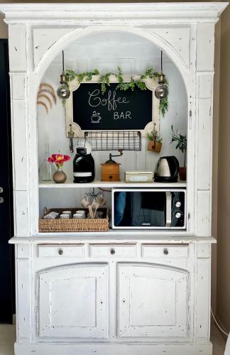a white hutch with a sign on top of it at La Villa Aux Oliviers in Flayosc