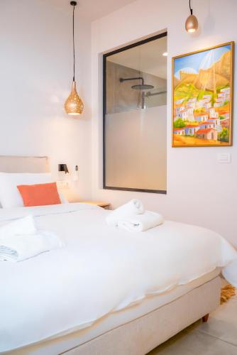 a bedroom with a white bed and a mirror at Princess Hotel in Lassi
