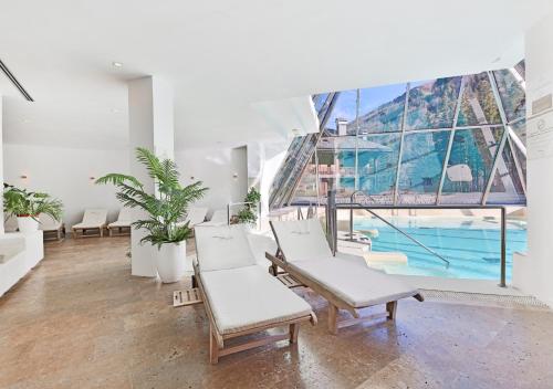 a living room with chairs and a swimming pool at Val di Luce SPA Resort in Abetone