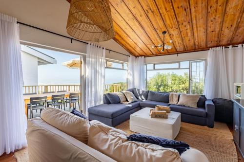 a living room with a couch and a table at Keurbooms Ocean View in Keurboomstrand