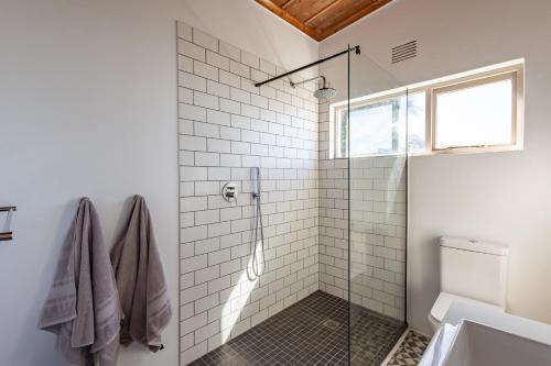 a bathroom with a shower with a glass door at Keurbooms Ocean View in Keurboomstrand