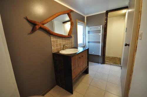 a bathroom with a sink and a fish on the wall at Lakeside Apartment in Ringgenberg