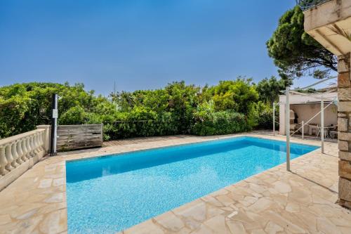 a swimming pool in the backyard of a house at Pinelodge Azure in Roquebrune-sur-Argens