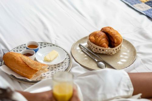 a table with two plates of bread and croissants at Hotel Naka in Diego Suarez