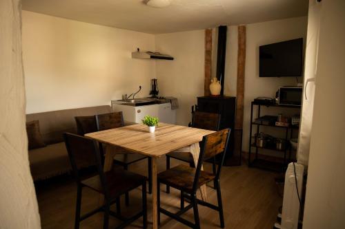 a dining room with a wooden table and chairs at La Mocha Casa Rural - La Casa de Ani in La Iruela