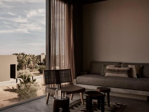 a living room with a couch and a large window at Casa Cook El Gouna - Adults Only in Hurghada