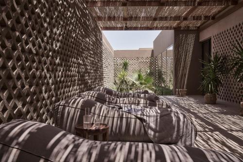 a living room with couches and a brick wall at Casa Cook El Gouna - Adults Only in Hurghada