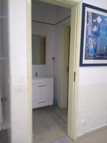a bathroom with a sink and a mirror at Melaya Budget Hostel in Faro