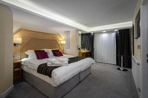 Ένα ή περισσότερα κρεβάτια σε δωμάτιο στο Granada Apartments Queens Mansions