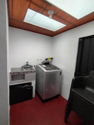 a small kitchen with a stove and a window at Donde Sara Tourist House in Murillo