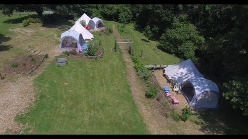 an aerial view of a group of tents on a field at Tente insolite en pleine nature in Tréduder