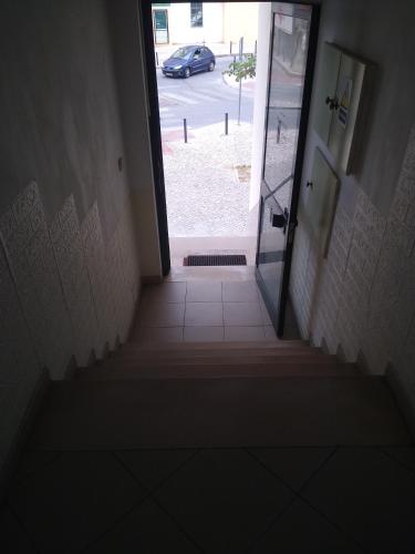 a stairway leading to a door in a hallway at Melaya Budget Hostel in Faro