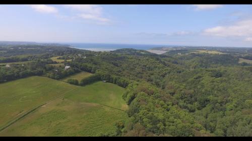 an aerial view of a green field with trees at Tente insolite en pleine nature in Tréduder