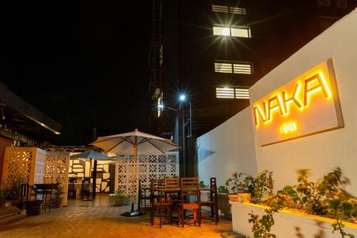 a restaurant with tables and umbrellas at night at Hotel Naka in Diego Suarez