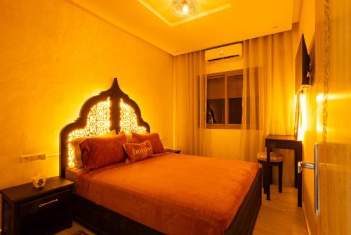 a bedroom with a bed in a yellow room at HAGS Apartment - Traditional Modern Apartment, full AC, 10m from airport in Marrakech