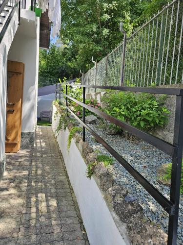 a fence next to a sidewalk next to a street at Casa Pina in Mioglia