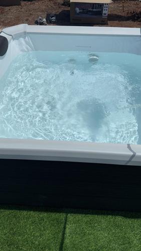 a bath tub filled with water on top of grass at Villa thomas torre vado san Gregorio in Marina San Gregorio