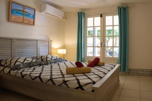 a bedroom with a large bed with two stuffed animals on it at VILLA Manja in La Saline les Bains