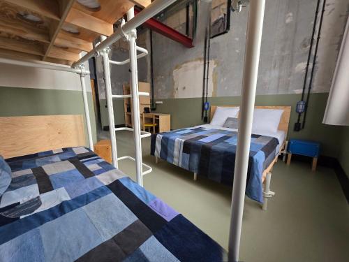 a bedroom with two bunk beds and a ladder at JAM Ghent in Ghent