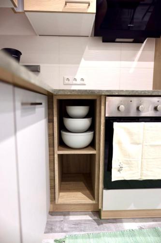 a kitchen with white bowls and plates in a cabinet at Apartment am Bödele in Telfes im Stubai