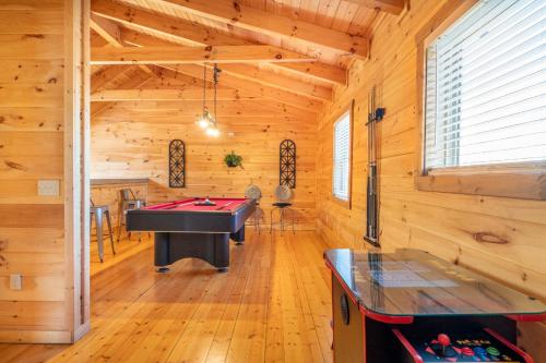 a room with a pool table in a log cabin at Cabin In The Mountains By Avada Properties in Sevierville